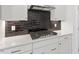 A kitchen displaying a cooktop with white cabinets and bronze hardware at 267 N Maple Walk Dr # 217, Garner, NC 27529