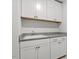 Convenient laundry room with white cabinets, granite countertops, and a sink at 267 N Maple Walk Dr # 217, Garner, NC 27529