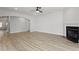 Cozy living room featuring luxury vinyl plank flooring, a fireplace, and natural light at 267 N Maple Walk Dr # 217, Garner, NC 27529