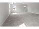 Primary bedroom with carpet, a tray ceiling, a ceiling fan and windows for plenty of natural light at 267 N Maple Walk Dr # 217, Garner, NC 27529
