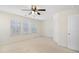 Bright, carpeted bedroom with a ceiling fan and multiple windows, offering a peaceful retreat at 2901 Benevolence Dr, Raleigh, NC 27610