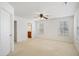 Spacious bedroom with neutral carpeting, ceiling fan, and abundant natural light from multiple windows at 2901 Benevolence Dr, Raleigh, NC 27610