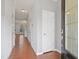 Bright hallway with hardwood floors leading to the main living areas of the home at 2901 Benevolence Dr, Raleigh, NC 27610