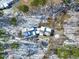 Aerial view of the home with trees and blue roof partially covered in snow at 316 Russ Rd, Smithfield, NC 27577