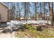 View of the backyard featuring mature trees and some snow on the ground at 316 Russ Rd, Smithfield, NC 27577