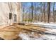 Backyard view featuring brick steps leading to the home with partial snow cover at 316 Russ Rd, Smithfield, NC 27577