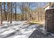 A snowy backyard with a storage shed and surrounding trees at 316 Russ Rd, Smithfield, NC 27577