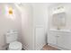 Charming powder room featuring a toilet, vanity, and designer light fixture at 316 Russ Rd, Smithfield, NC 27577