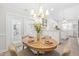 Dining area with a wood table set for four, leading into a well-lit, white kitchen at 316 Russ Rd, Smithfield, NC 27577