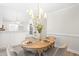 Bright dining area featuring a chandelier, table setting, and a view into the adjacent kitchen at 316 Russ Rd, Smithfield, NC 27577
