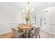 Cozy dining room with modern light fixture, a table set for four, and a patio door at 316 Russ Rd, Smithfield, NC 27577