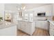 Open concept white kitchen with granite countertops, stainless appliances, and modern lighting at 316 Russ Rd, Smithfield, NC 27577