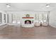 Bright Living room featuring a brick fireplace and a view to the backyard at 316 Russ Rd, Smithfield, NC 27577