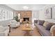 Inviting living room with a brick fireplace, neutral furnishings, and plenty of natural light at 316 Russ Rd, Smithfield, NC 27577