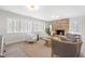 Cozy living room featuring brick fireplace, two armchairs, and a comfortable gray sofa at 316 Russ Rd, Smithfield, NC 27577