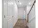 Bright hallway with white doors, wood-look flooring, and staircase leading to the upper level at 326 Church St # 42, Wendell, NC 27591