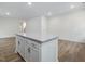 Modern kitchen island with granite countertops and white cabinets stands out in the open-concept space at 326 Church St # 42, Wendell, NC 27591