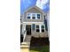 Charming two-story townhome showcasing stone accents, neutral siding, and bright white trim at 328 Church St # 43, Wendell, NC 27591