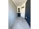 Inviting covered porch with a gray concrete floor and stylish blue siding at 328 Church St # 43, Wendell, NC 27591