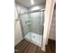 Contemporary shower with sleek glass doors, gray tile surround, and chrome fixtures at 328 Church St # 43, Wendell, NC 27591