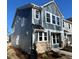 Two-story home with light-blue siding, multiple windows, and a stone facade for a charming, modern look at 334 Church St # 46, Wendell, NC 27591