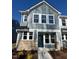 Charming two-story home with light-blue siding, white trim, and a well-manicured front yard at 334 Church St # 46, Wendell, NC 27591