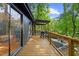 Large wooden back deck with a grill, seating area, and wooded views at 3506 Bellevue Rd, Raleigh, NC 27609