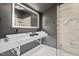 Modern bathroom with double square sinks, illuminated mirror, and a glass-enclosed shower at 3506 Bellevue Rd, Raleigh, NC 27609