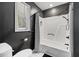 Bathroom with a shower-tub combination featuring a white shower curtain and gray walls at 3506 Bellevue Rd, Raleigh, NC 27609