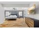 Stylish bedroom with a gray accent wall, hardwood floors, modern furniture, and a ceiling fan at 3506 Bellevue Rd, Raleigh, NC 27609