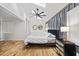 Bright bedroom featuring a sloped ceiling, hardwood floors, and a gray panel accent wall at 3506 Bellevue Rd, Raleigh, NC 27609