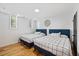 Bedroom featuring two beds, hardwood floors and a window at 3506 Bellevue Rd, Raleigh, NC 27609