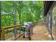 Outdoor deck featuring a stainless steel grill and lush greenery at 3506 Bellevue Rd, Raleigh, NC 27609