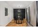 Dining area with hardwood floors, stainless steel refrigerator and black dining room table at 3506 Bellevue Rd, Raleigh, NC 27609