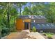 Unique exterior view of home with wood and dark siding, natural landscaping, and a wood deck entry at 3506 Bellevue Rd, Raleigh, NC 27609