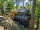 Unique exterior elevation featuring an elevated deck entrance and modern design with skylights at 3506 Bellevue Rd, Raleigh, NC 27609