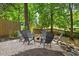 Charming backyard fire pit area with Adirondack chairs, perfect for outdoor gatherings in a lush, green setting at 3506 Bellevue Rd, Raleigh, NC 27609