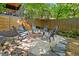 Backyard area with a charming fire pit surrounded by Adirondack chairs and a wooden fence, perfect for entertaining at 3506 Bellevue Rd, Raleigh, NC 27609