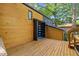 Inviting front entrance with stained wood siding and a wooden deck that offers a warm, natural aesthetic at 3506 Bellevue Rd, Raleigh, NC 27609