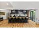 Spacious kitchen featuring black cabinets, stainless steel appliances, large island and hardwood floors at 3506 Bellevue Rd, Raleigh, NC 27609