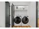 Bright laundry room with new Whirlpool washer and dryer, storage shelves, and stylish containers at 3506 Bellevue Rd, Raleigh, NC 27609