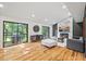 Bright living room with hardwood floors, white and gray walls, and sliding glass doors at 3506 Bellevue Rd, Raleigh, NC 27609