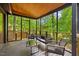 Relaxing screened porch with stylish outdoor furniture overlooking the backyard at 3506 Bellevue Rd, Raleigh, NC 27609