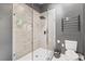 Modern shower with gray tile, a rainfall shower head, and a heated towel rack at 3506 Bellevue Rd, Raleigh, NC 27609