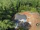 Overhead aerial shot revealing the new home’s layout, set within a dense, green landscape at 3601 Alamance Dr, Raleigh, NC 27609