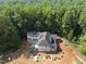 Bird's eye view showcases the new home's location surrounded by a canopy of mature trees at 3601 Alamance Dr, Raleigh, NC 27609