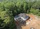 High angle aerial perspective of a modern home under construction nestled among mature trees at 3601 Alamance Dr, Raleigh, NC 27609