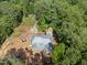 An aerial shot captures a new home construction site bordered by mature trees at 3601 Alamance Dr, Raleigh, NC 27609