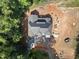 A top-down aerial view of the home with a new roof amidst a verdant forest in a secluded location at 3601 Alamance Dr, Raleigh, NC 27609