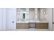 Elegant bathroom with double vanity, marble countertop, decorative sconces and modern fixtures at 3601 Alamance Dr, Raleigh, NC 27609